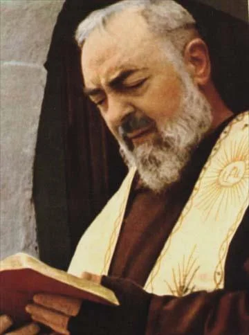 Saint Padre Pio reading from a religious book, symbolizing prayer, devotion, and spiritual reflection