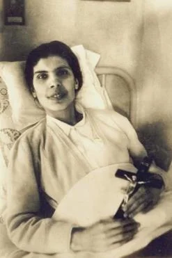 Catholic nun Saint lying in bed, image of faith and suffering.