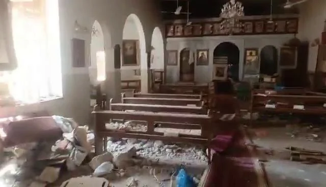 Damaged Catholic church interior showing pews and altar — Catholic Family Newsletter