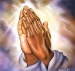 Hands joined in prayer with heavenly light — Catholic Family Newsletter.