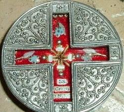 Close-up of the Precious Relic of the True Cross encased in a decorative silver Catholic reliquary.